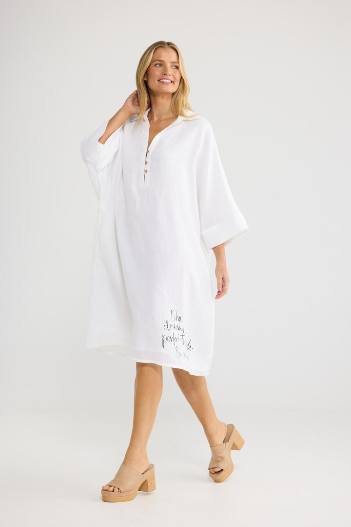 Model wearing Casablanca Tunic in white linen, front view.